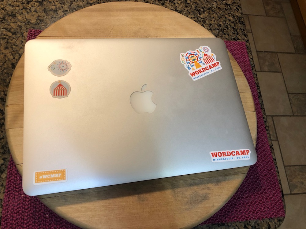 Laptop with stickers all ready for WordCamp